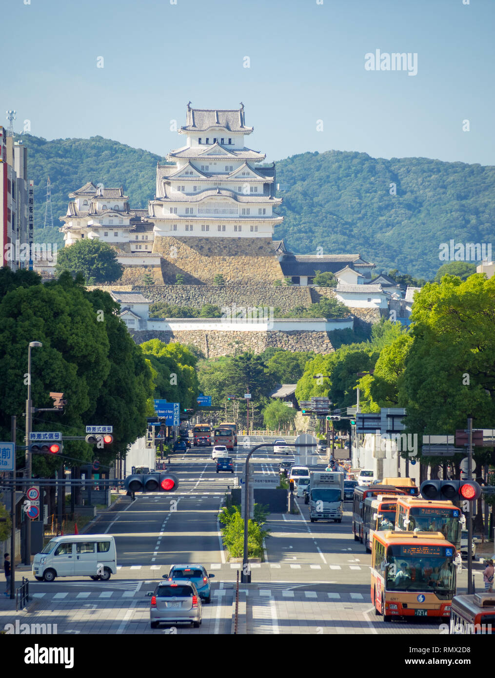 A view of Ootemae-dori (Ootemae Street), the main street, and Himeji Castle (Himeji-jo) rising in the background, in Himeji, Hyogo Prefecture, Japan. Stock Photo