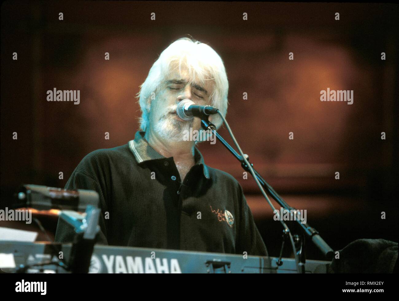 R&B, soul singer and songwriter Michael McDonald is shown performing on stage during a 'live' concert appearance. Stock Photo