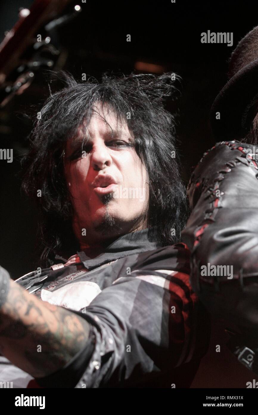 Bassist, author and photographer Nikki Sixx of the heavy metal band Motley Crue is shown performing on stage during a 'live' concert appearance. Stock Photo