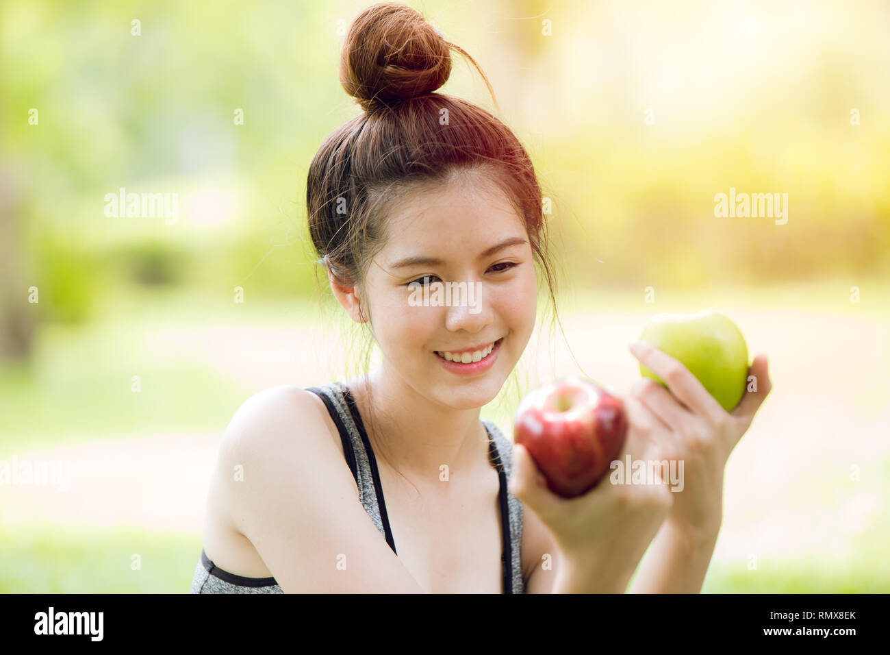apple in Asian girl hand, green or red apple color fruit choice for healthy people concept. Stock Photo