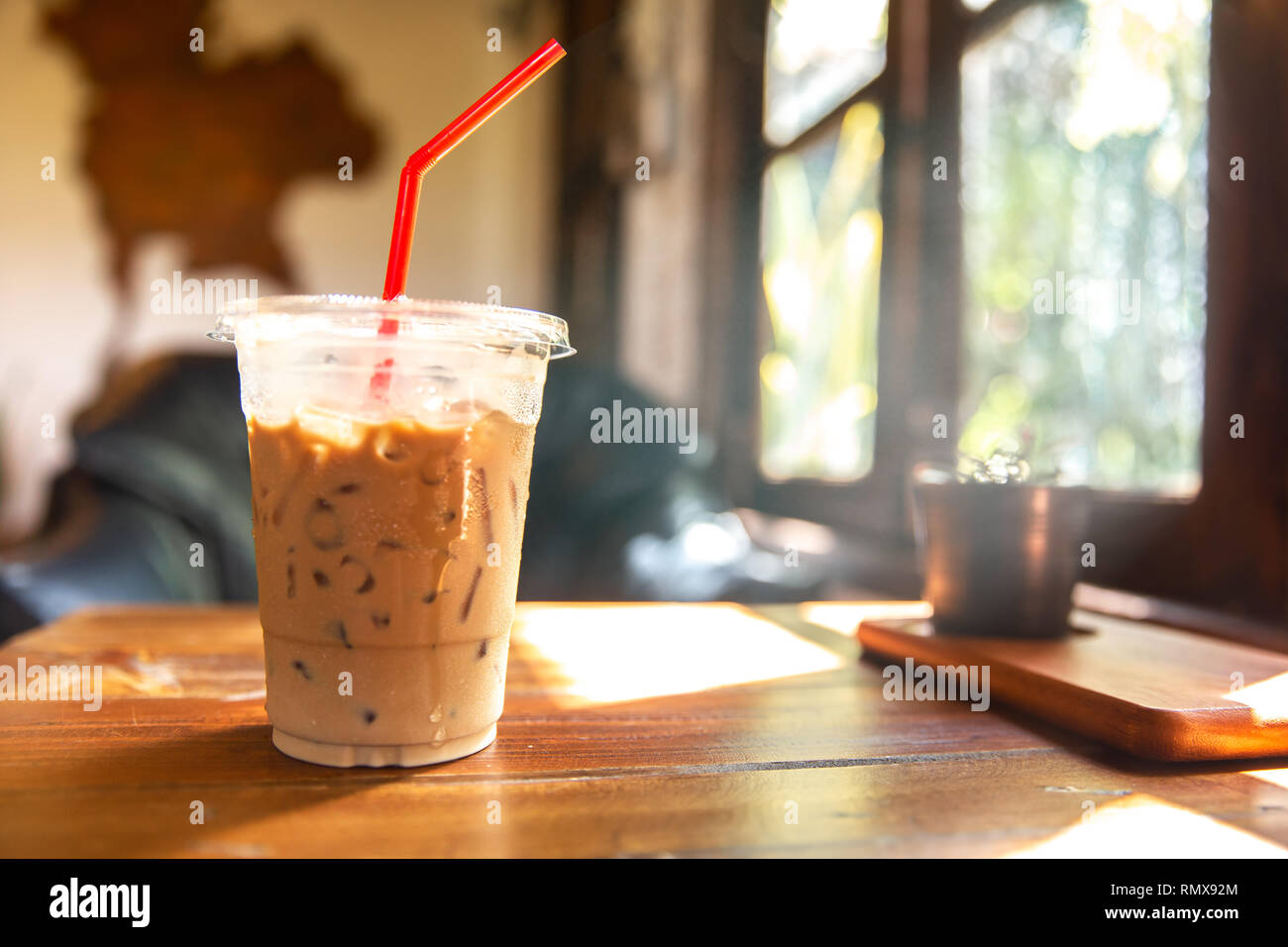 https://c8.alamy.com/comp/RMX92M/ice-coffee-on-wooden-table-at-cafe-windows-morning-sunlight-RMX92M.jpg
