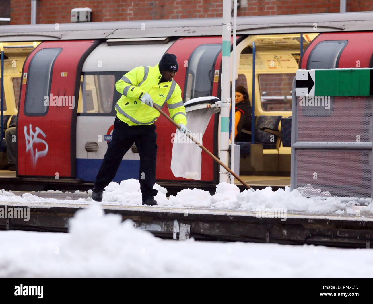 Pic shows: Snow and sleet hampered commuters on their work today in East Finchley, North London  Man clearing platform at the tube station     pic by  Stock Photo