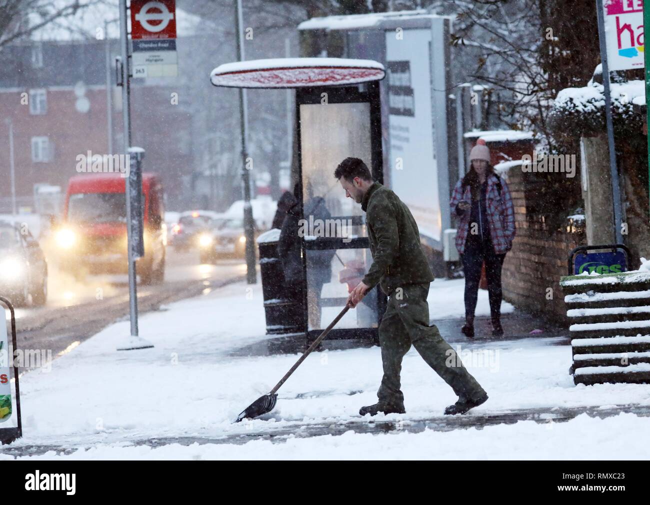 Pic shows: Snow and sleet hampered commuters on their work today in East Finchley, North London  Clearing up outside his flower shop     pic by Gavin  Stock Photo