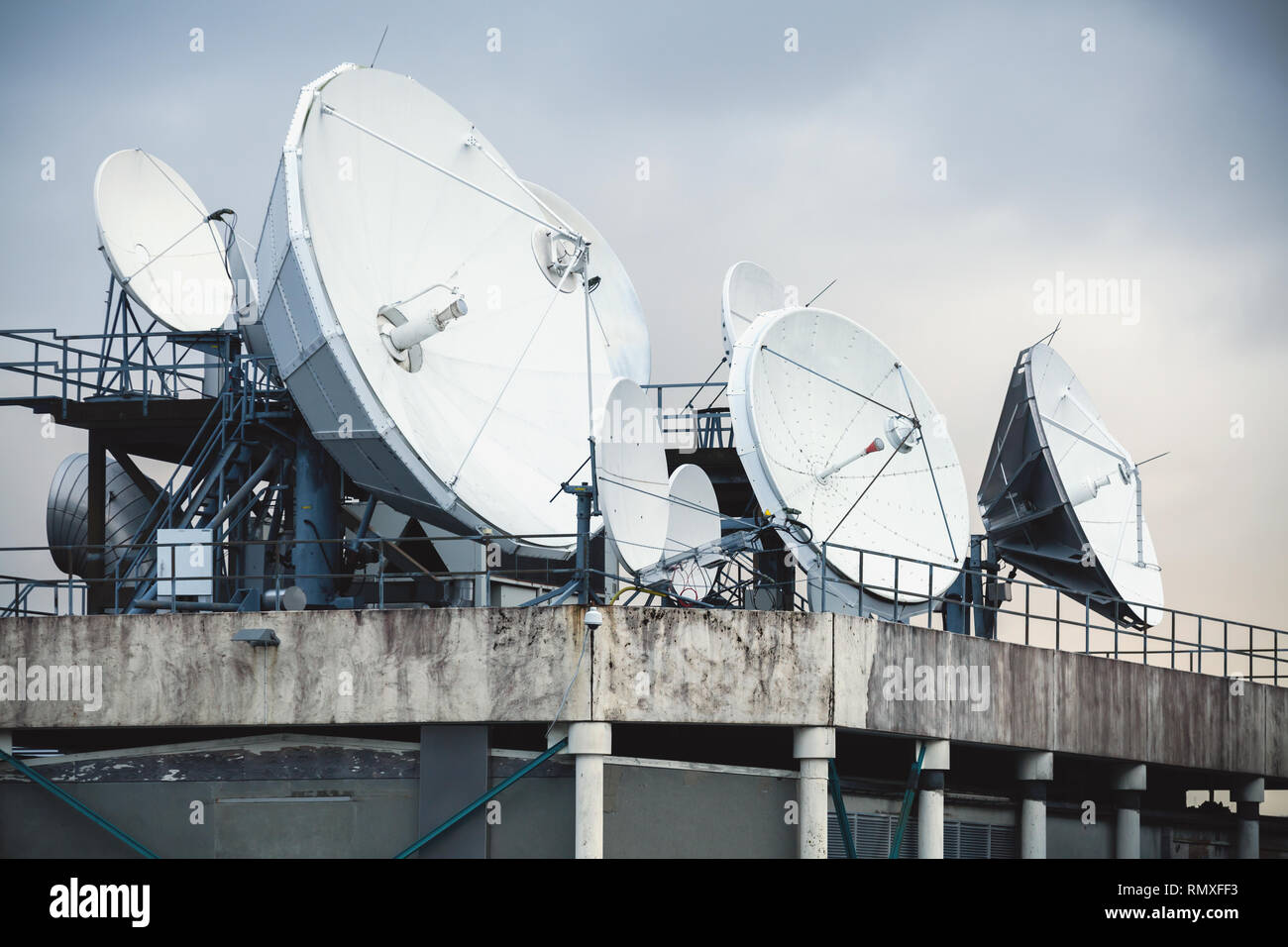 Satellite dish antennas mounted on the roof of an industrial building Stock Photo Alamy