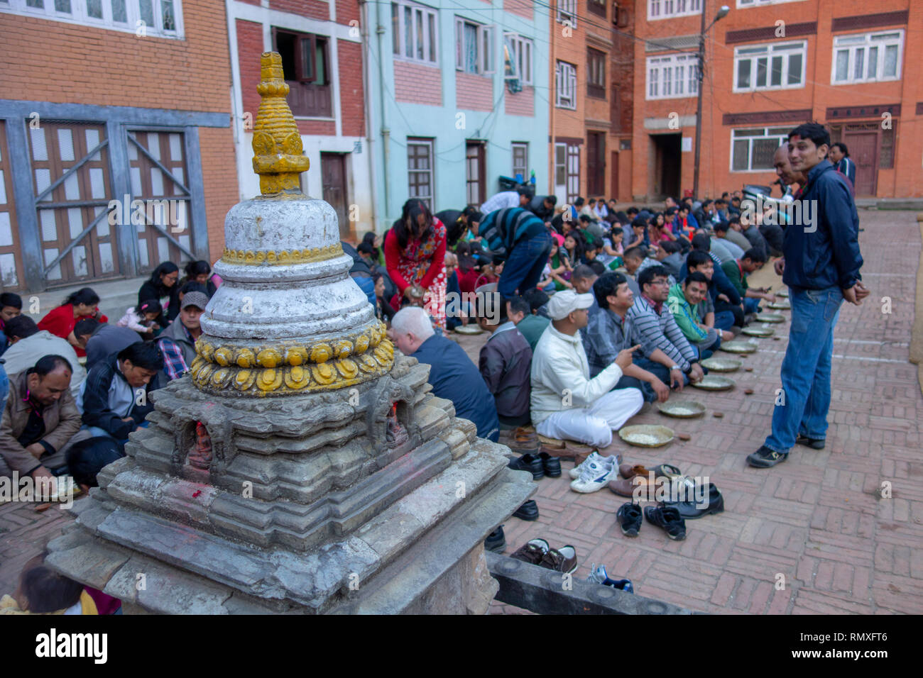 GOLDEN TEMPLE, KATHMANDU, NEPAL-CIRCA 2013 : Nepalese wait for religious meal offered by a local Hindu temple in Kathmandu, Nepal Stock Photo