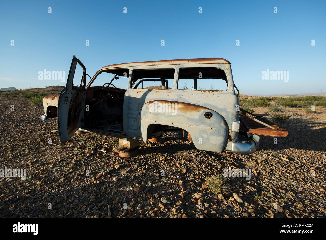 An old, rusty abandoned car in the desert of West Texas. Stock Photo