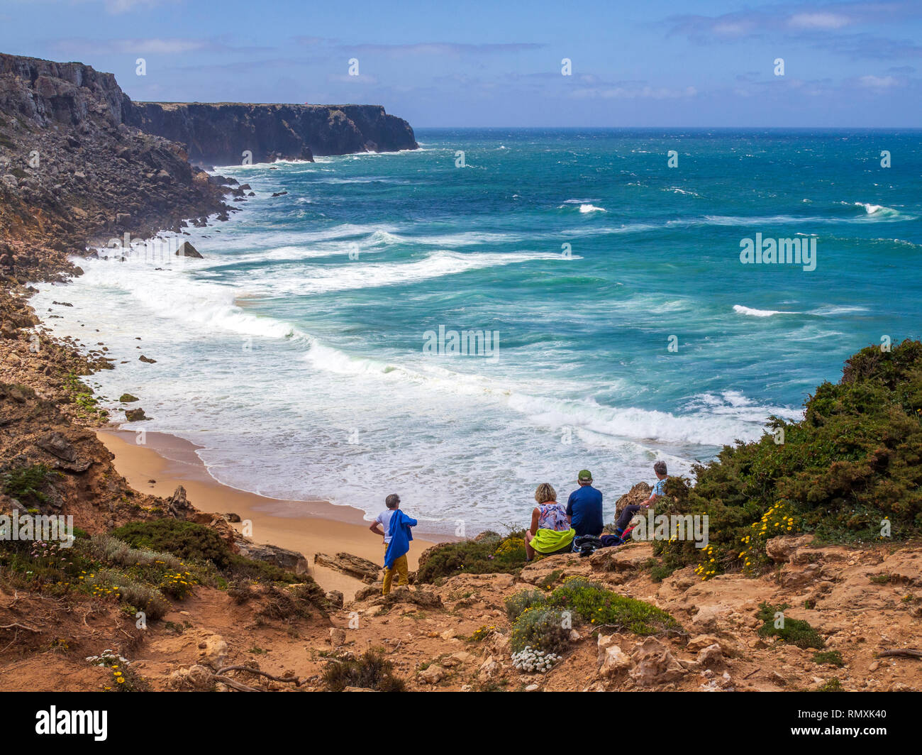 Trekkers enjoying the view towards Cape St. Vincent on the Rota Vicentina trail, a multi-day walk in south west Portugal. Stock Photo