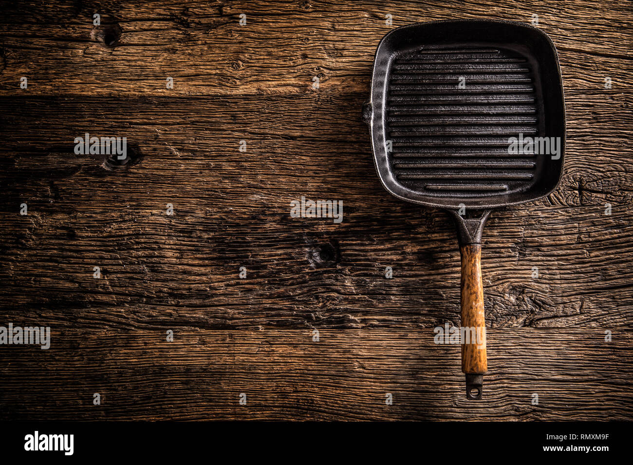 Empty old grill pan on rustic oak table - top of view. Stock Photo