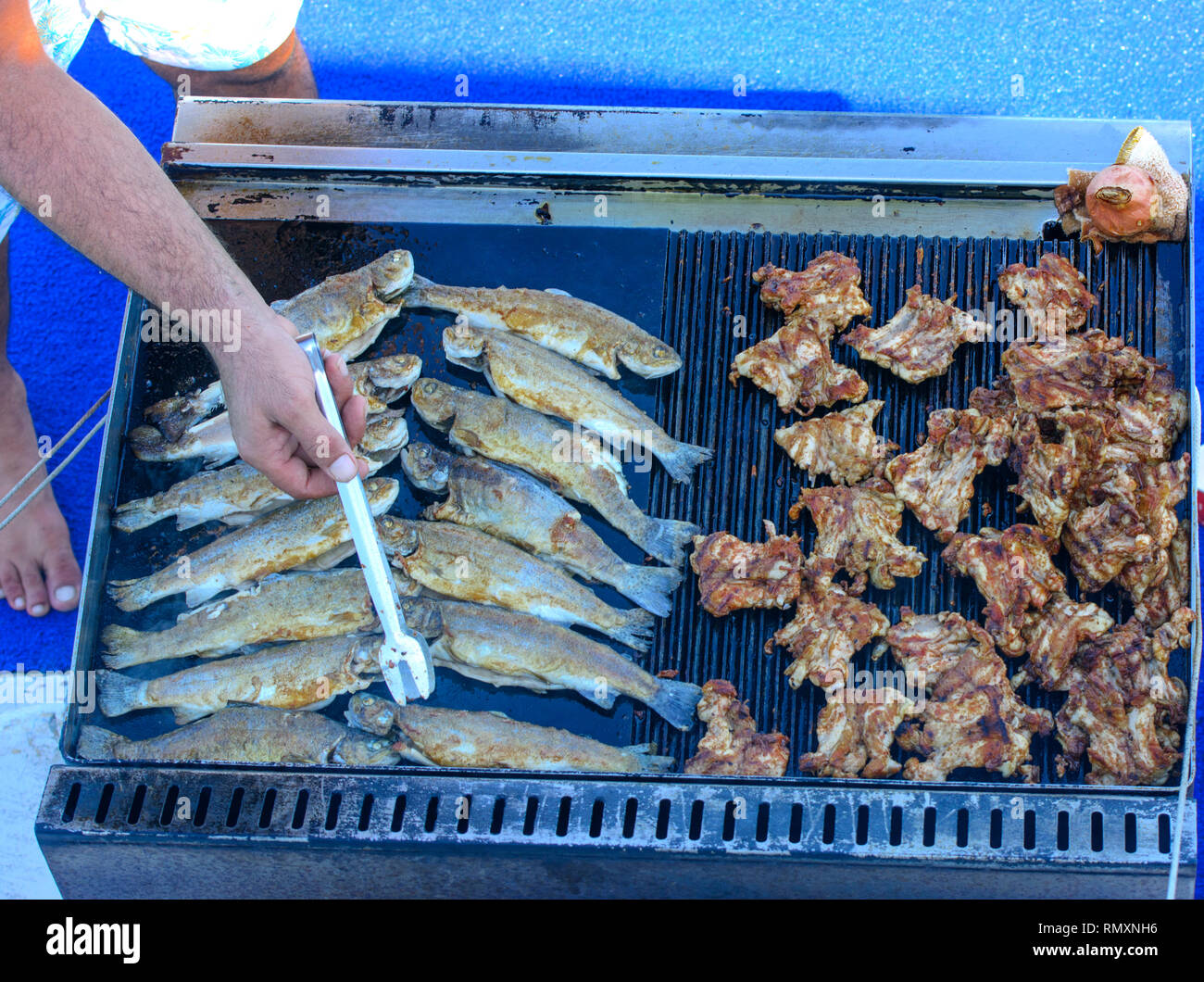 Beautifully cooked fried pieces of quail meat and whole trout fish on