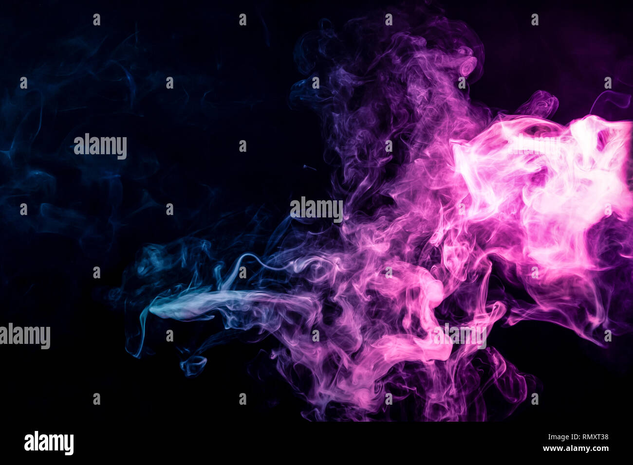 Dense multicolored smoke of blue and purple colors on a black isolated ...