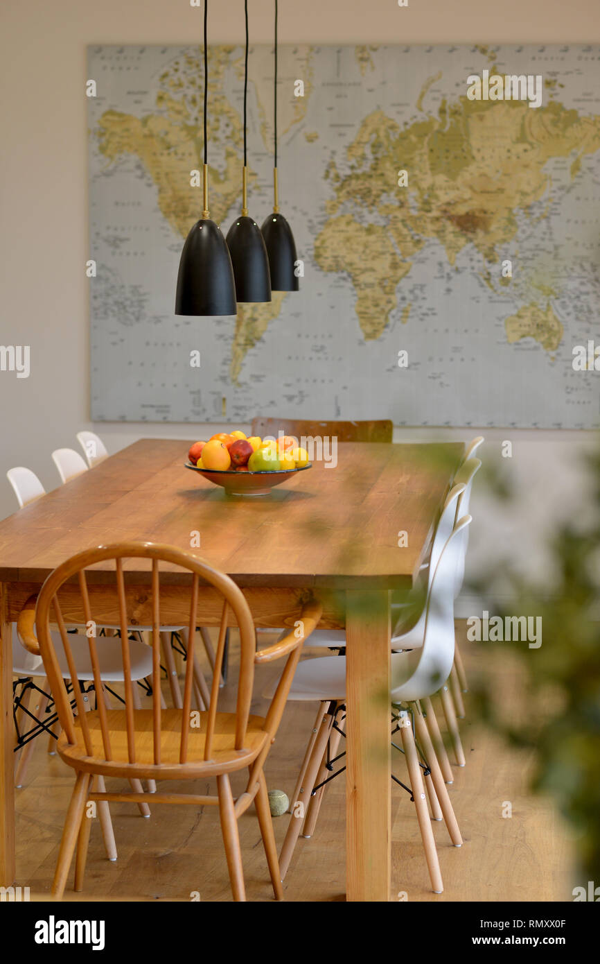 Dining room table with wall map. Stock Photo