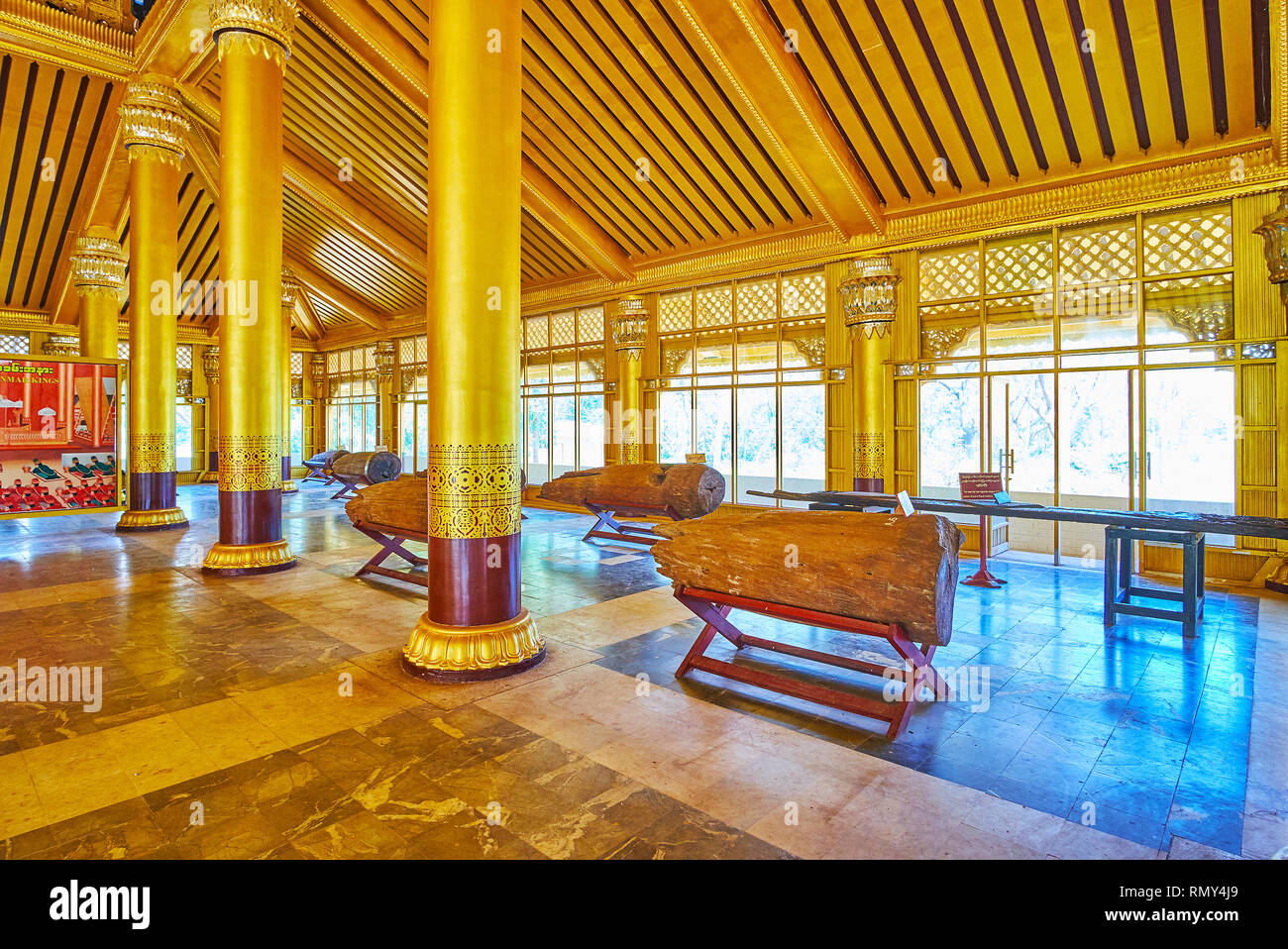 BAGO, MYANMAR - FEBRUARY 15, 2018: The parts of preserved teakwood columns in restored Great Audience Hall (Lion Throne Hall) of Kanbawzathadi Golden  Stock Photo