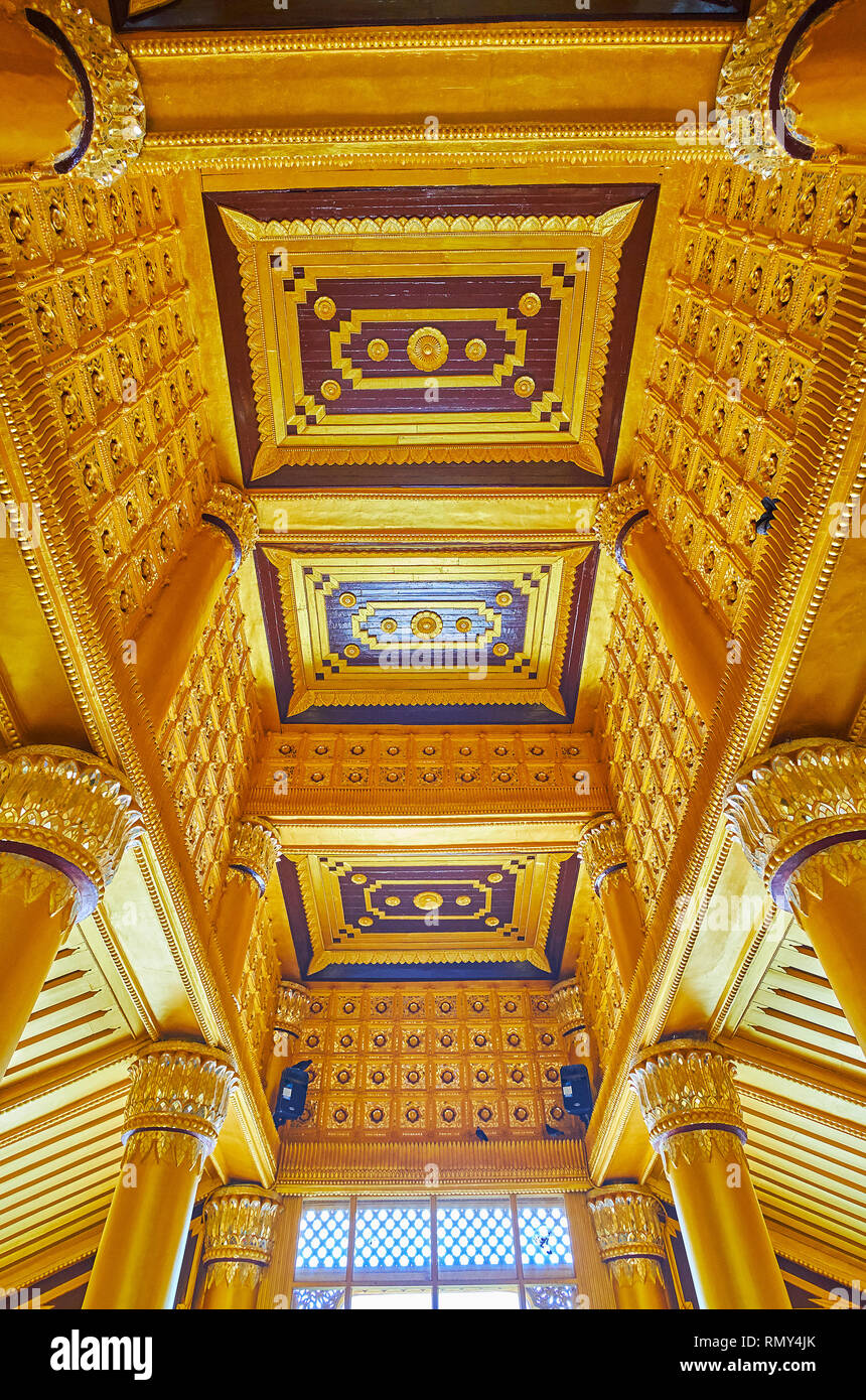 BAGO, MYANMAR - FEBRUARY 15, 2018: The ornate wooden ceiling in Lion Throne Hall (Great Audience Hall) of Kanbawzathadi Golden palace with carved patt Stock Photo