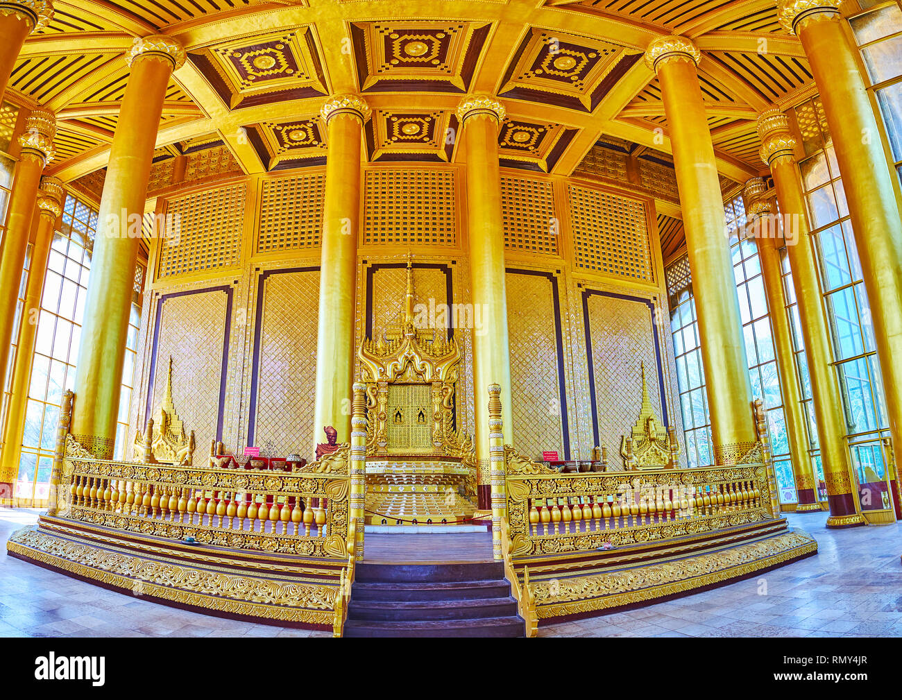 BAGO, MYANMAR - FEBRUARY 15, 2018: The richly decorated interior of Great Audience Hall of Kanbawzathadi Golden palace with Thihathana (Lion) Trone in Stock Photo