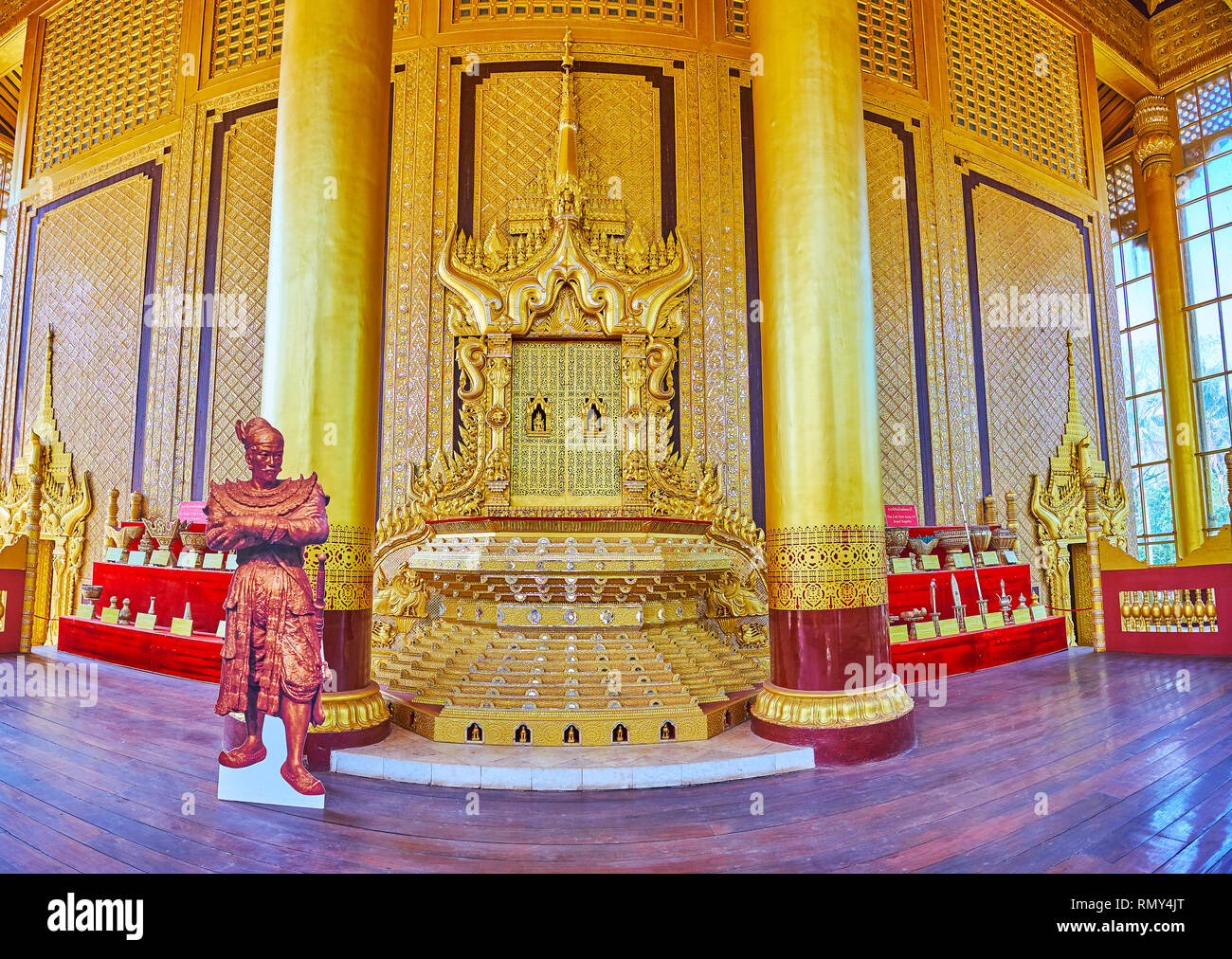 BAGO, MYANMAR - FEBRUARY 15, 2018: The complex decoration of Thihathana (Lion) Trone with carved patterns, sculptures and mirrorwork, Great Audience H Stock Photo