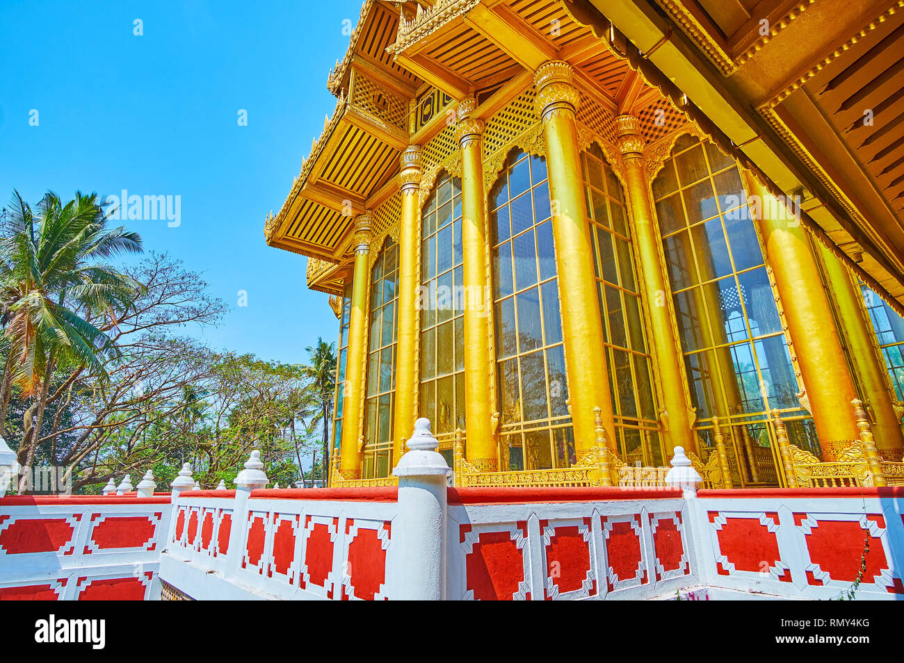 Details of exterior of Kanbawzathadi Golden palace with tall windows, streight pillars, fine carvings and gilding, Bago, Myanmar Stock Photo