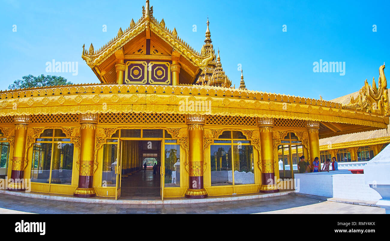 BAGO, MYANMAR - FEBRUARY 15, 2018: The wing of Great Audience Hall (Lion Throne Hall) of Kanbawzathadi Golden palace with gilding, ornate wooden carvi Stock Photo