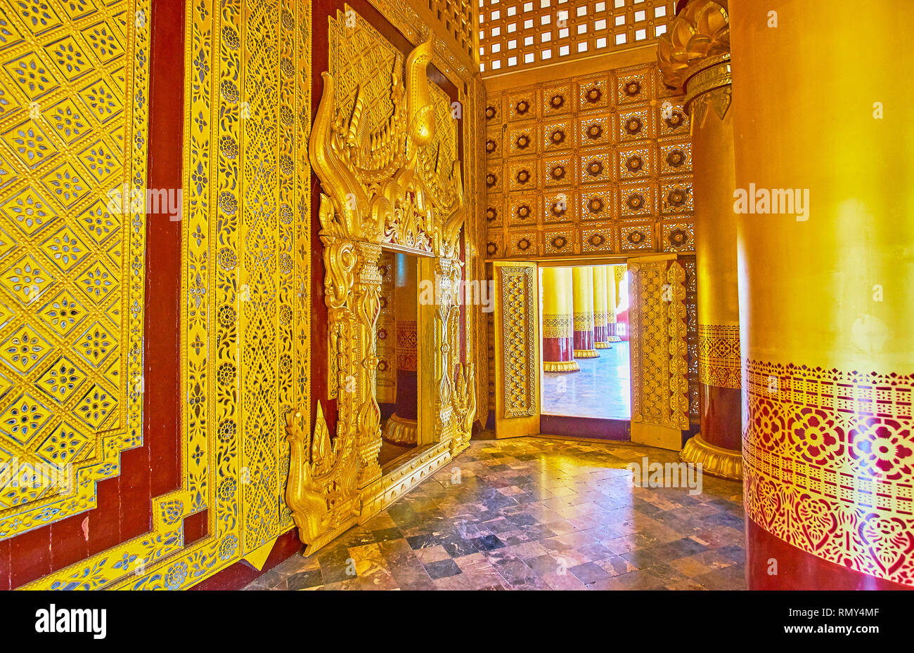 BAGO, MYANMAR - FEBRUARY 15, 2018: Interior details of Bee (Bhammayarthana) Throne Hall of Kanbawzathadi palace with fine mirrorwork and complex woode Stock Photo