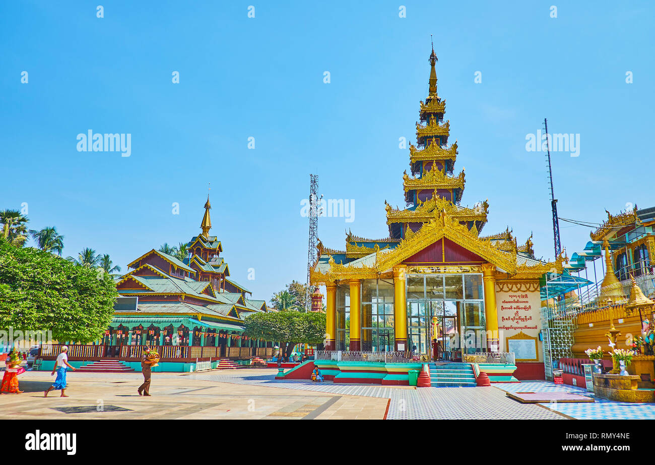 BAGO, MYANMAR - FEBRUARY 15, 2018: The ornate shrines of Shwemawdaw Paya decorated with pyatthat (multitired) roofs, gilt and carved wooden patterns, Stock Photo