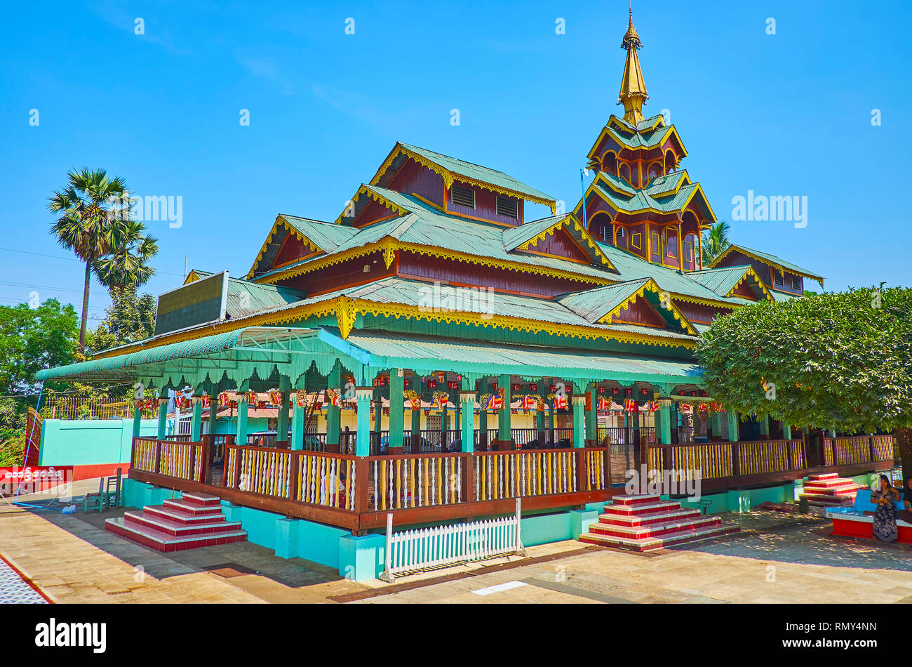 BAGO, MYANMAR - FEBRUARY 15, 2018: The colorful wooden pilgrims pavilion at the North gate of Shwemawdaw Pagoda is decorated with carved patterns and  Stock Photo