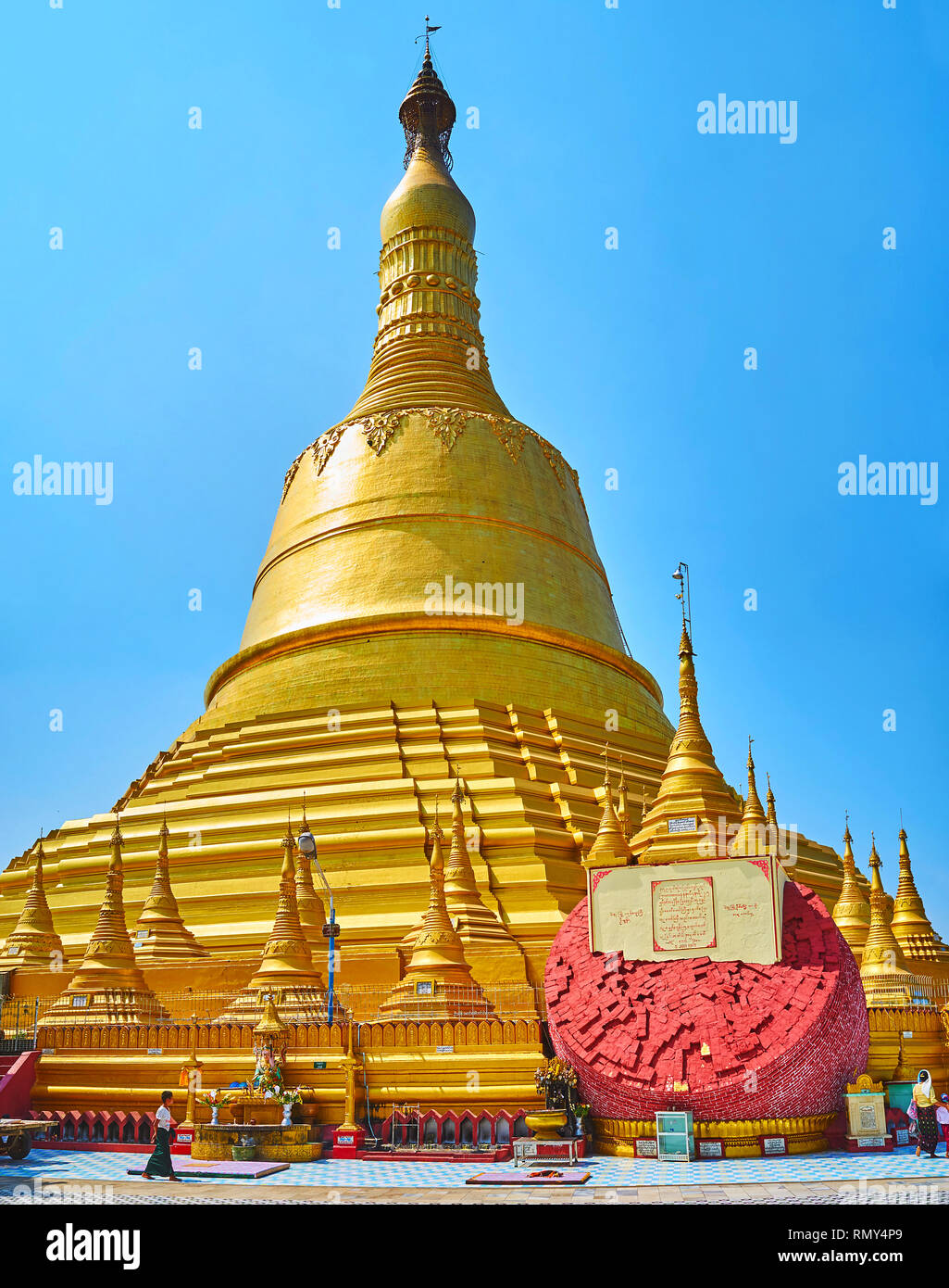 BAGO, MYANMAR - FEBRUARY 15, 2018: Panorama of the gilded stupa of Shwemawdaw Paya and the brick block at its foot, collapsed during the earthquake, o Stock Photo