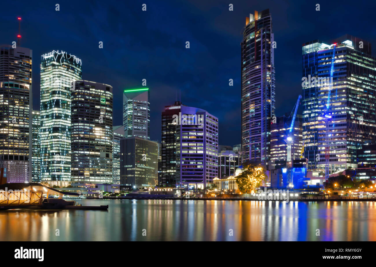 City skyline Illuminated at night, showing light reflections on the ...