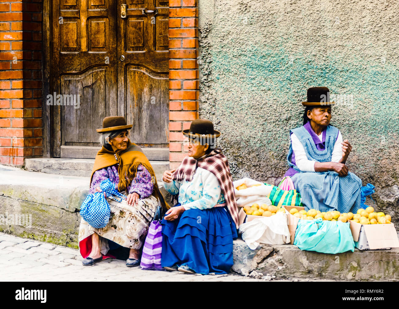 Coroico, Bolivia on 3rd May 2017: View on group of indigenous woman selling local products on market Stock Photo