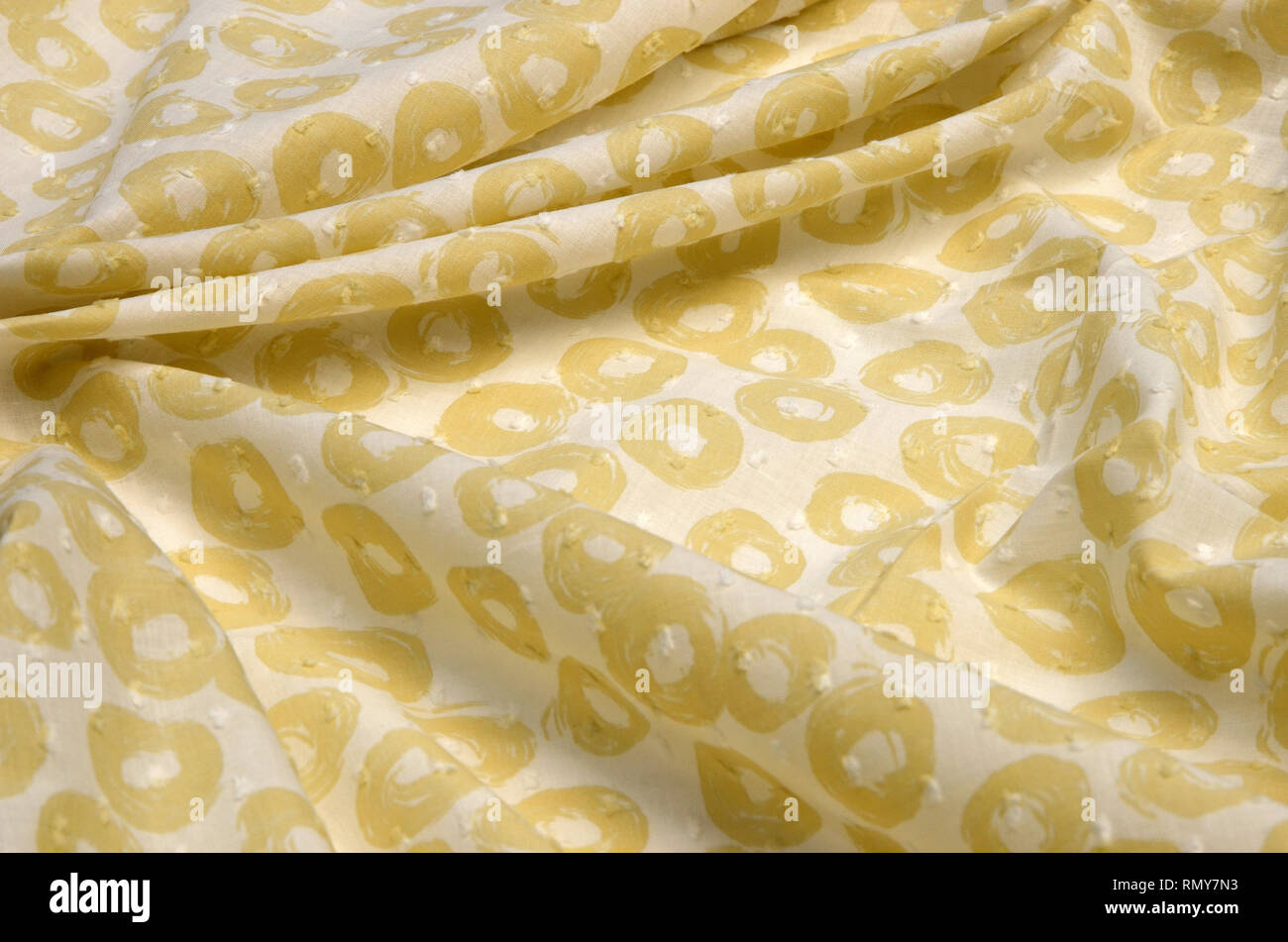 Cloth cotton, cambric in yellow polka dots on white Stock Photo
