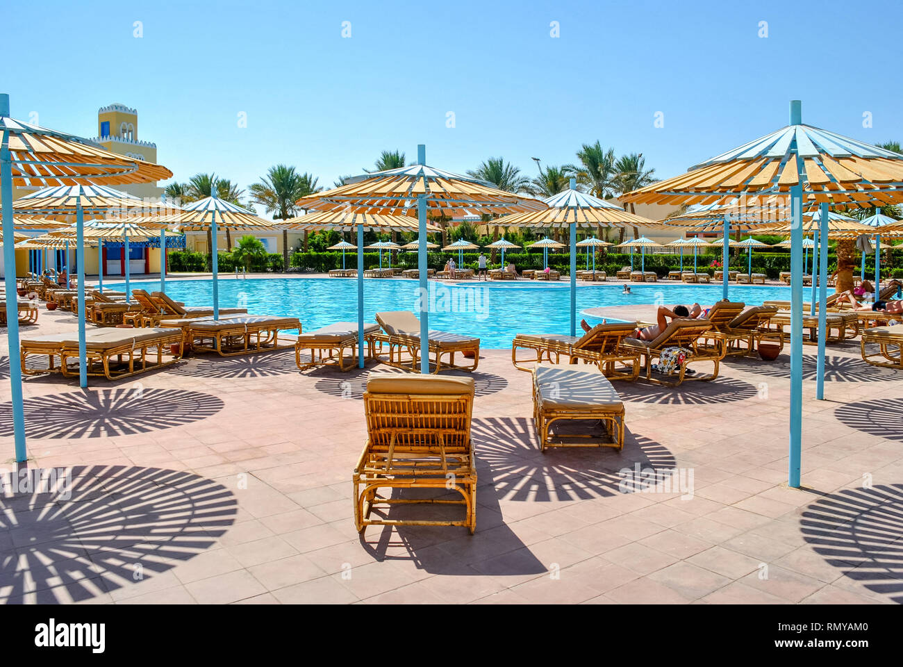 Loungers by the pool in the tourist resort town of Hurghada, Egypt Stock Photo