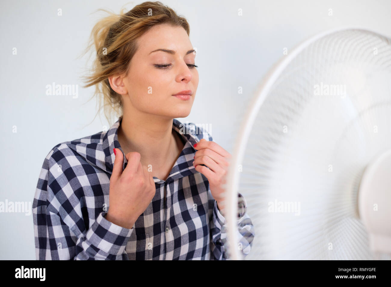 Girl trying to refresh from the summer heat haze Stock Photo