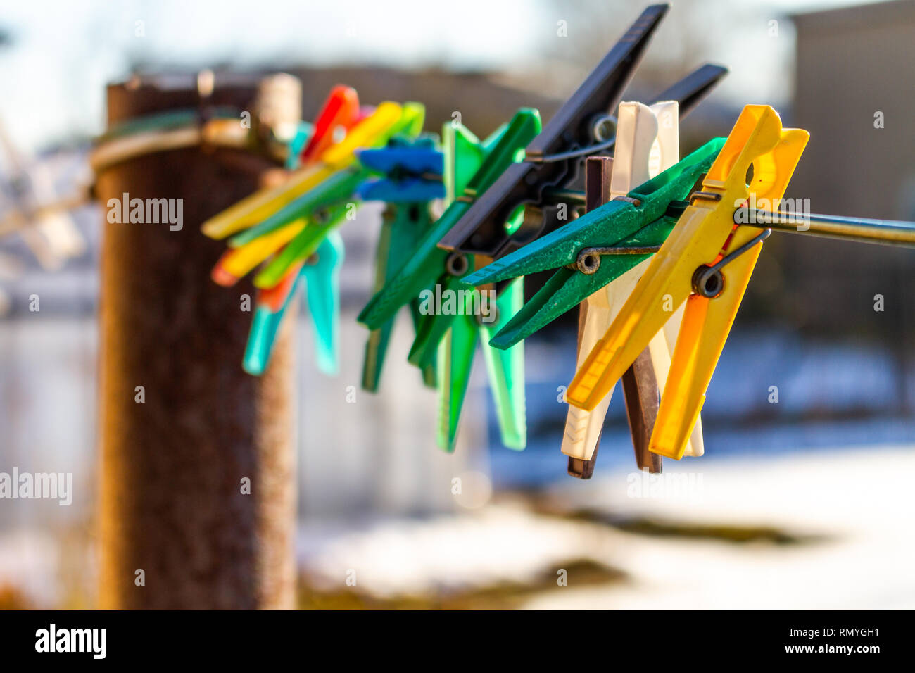 Colorful clothes pins isolated on a line in spring Stock Photo