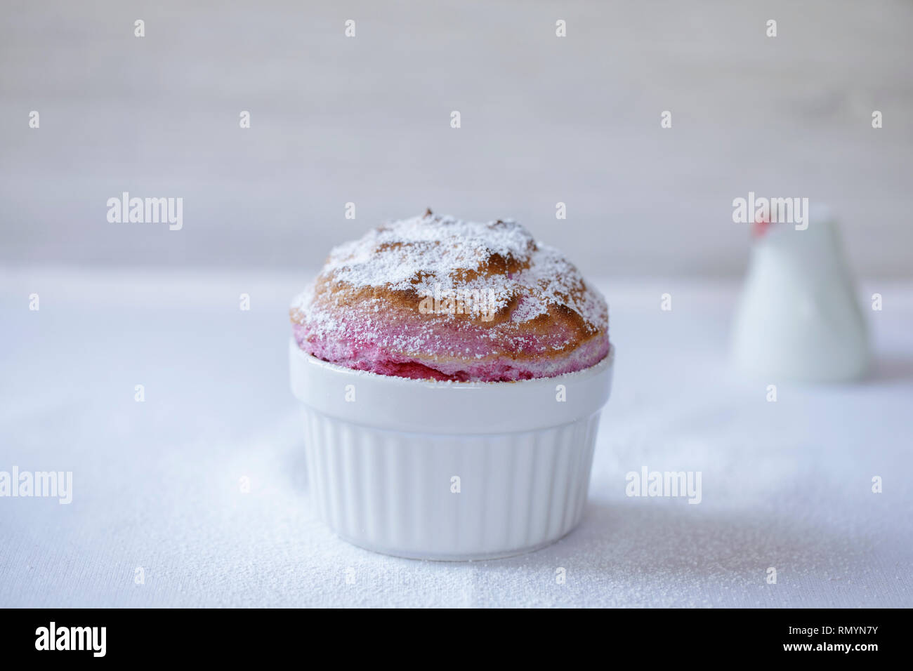 Raspberry souffle in a white ramekin Stock Photo Alamy