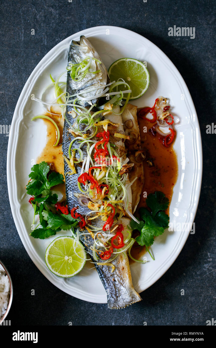 Whole sea bass baked with Thai spices Stock Photo - Alamy