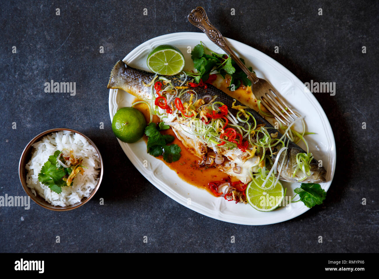 Whole sea bass baked with Thai spices Stock Photo - Alamy