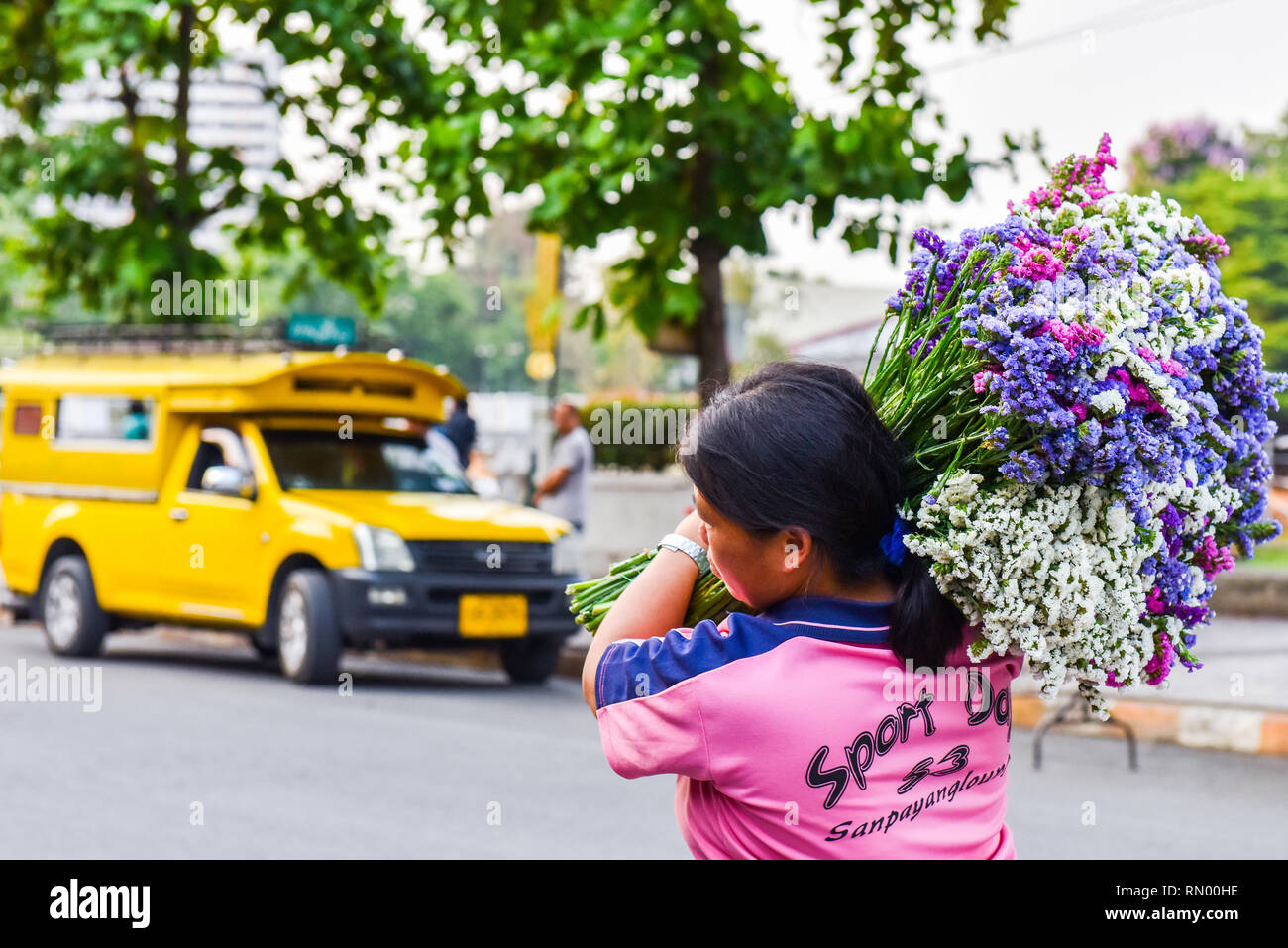 Woman transporting flowers, Chiang Mai, Thailand Stock Photo