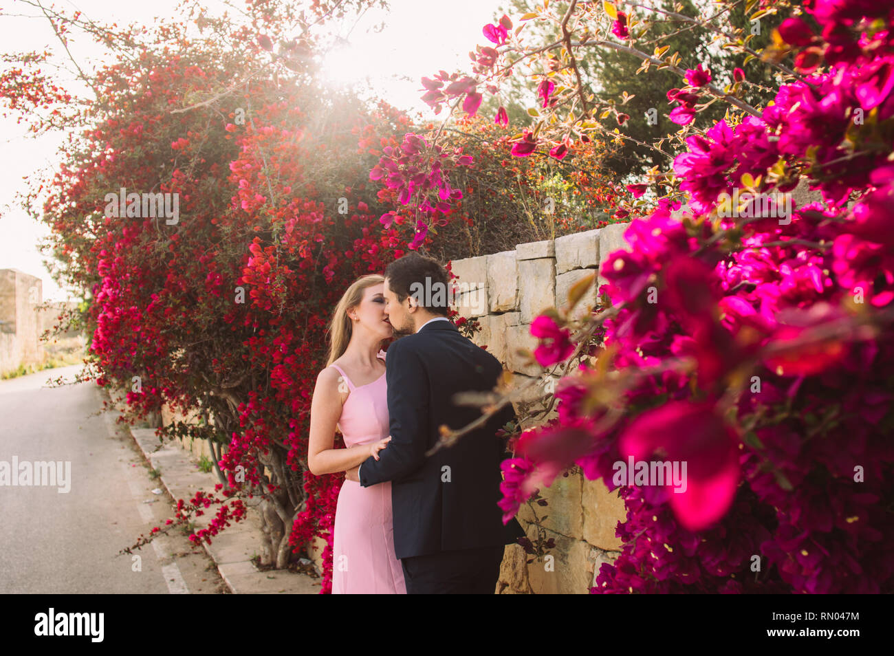 Young man kissing woman flowers hi-res stock photography and images - Alamy