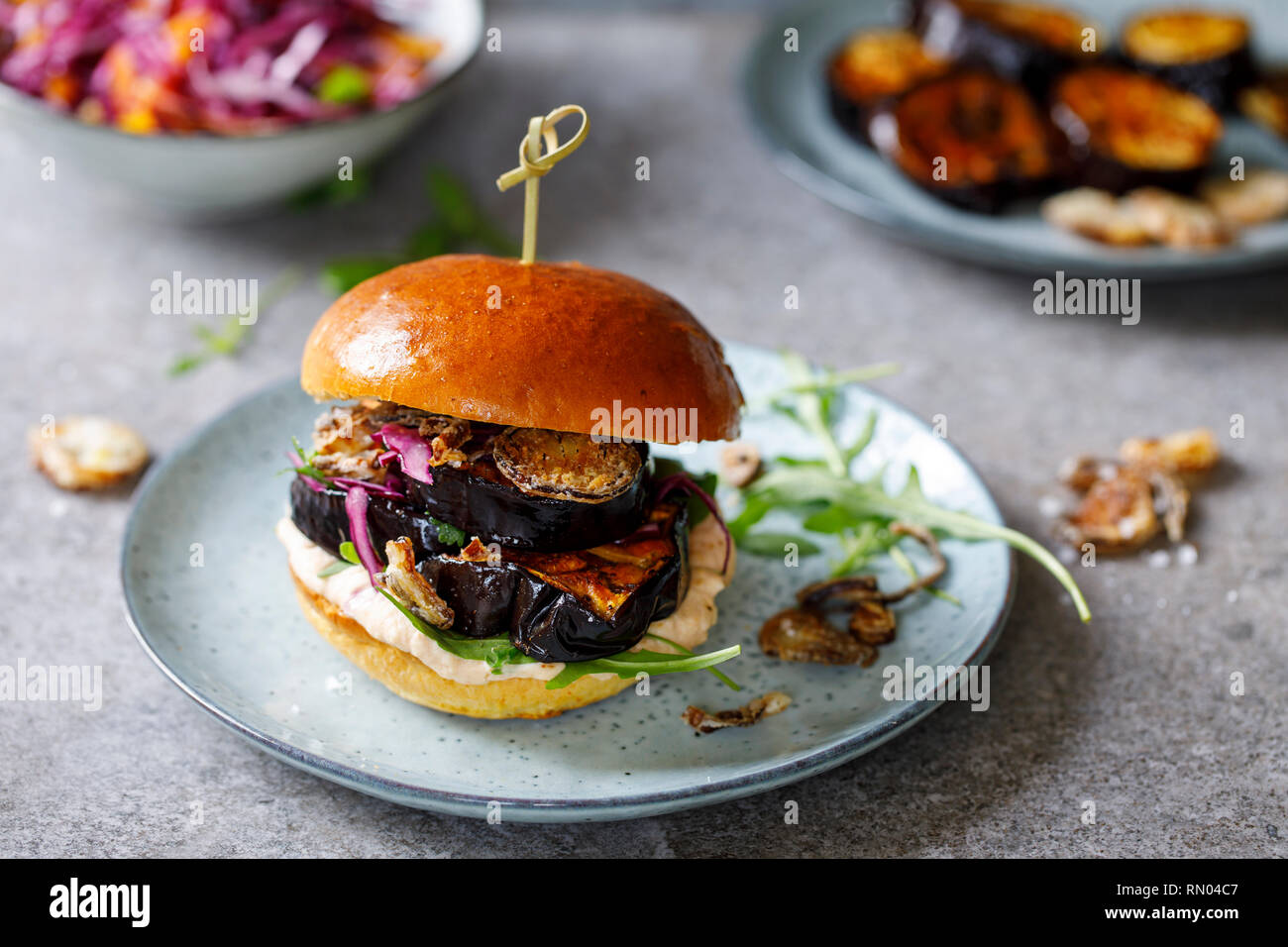 Vegan burger with white bean puree and spicy aubergine slices Stock Photo