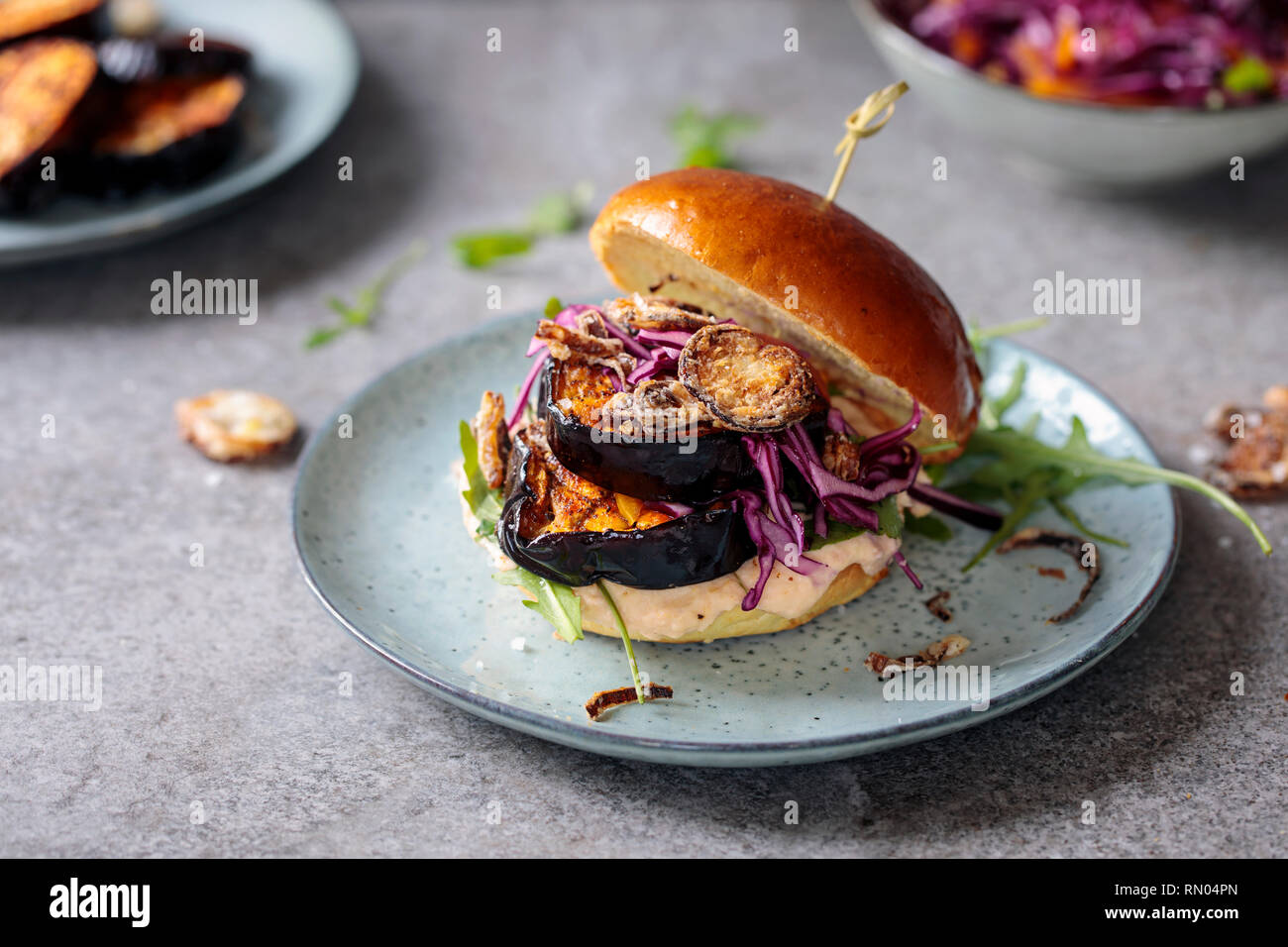 Vegan burger with white bean puree and spicy aubergine slices Stock Photo
