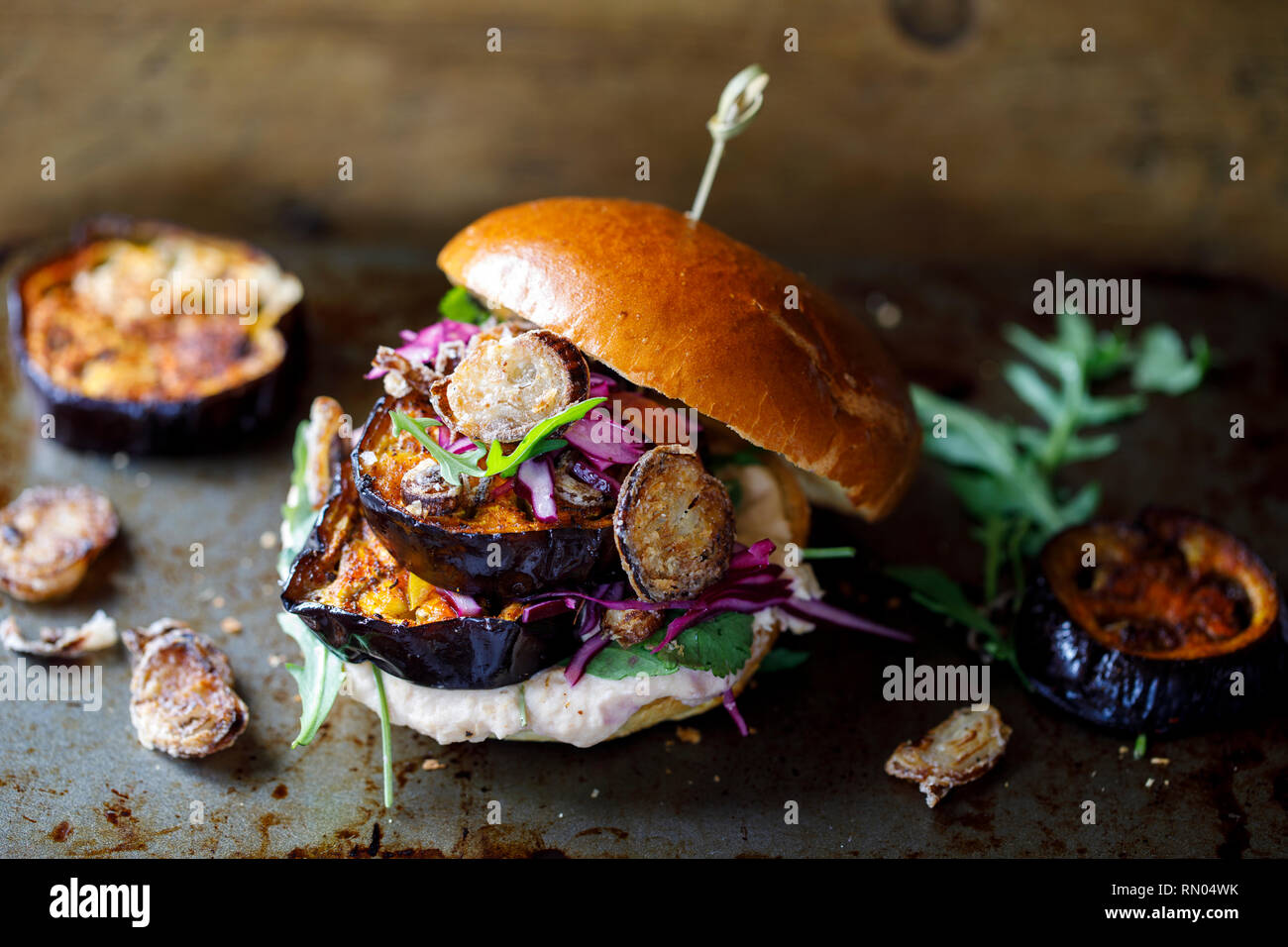 Vegan burger with white bean puree and spicy aubergine slices Stock Photo