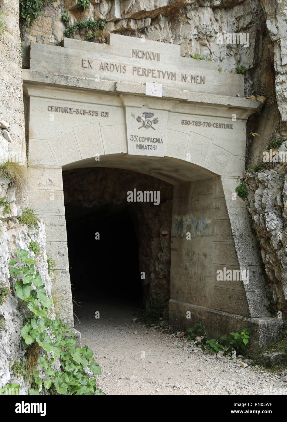 First tunnel of the Tunnel Road on Mount Pasubio with the inscription of the army group that with sacrifice built the tunnels during the First World W Stock Photo