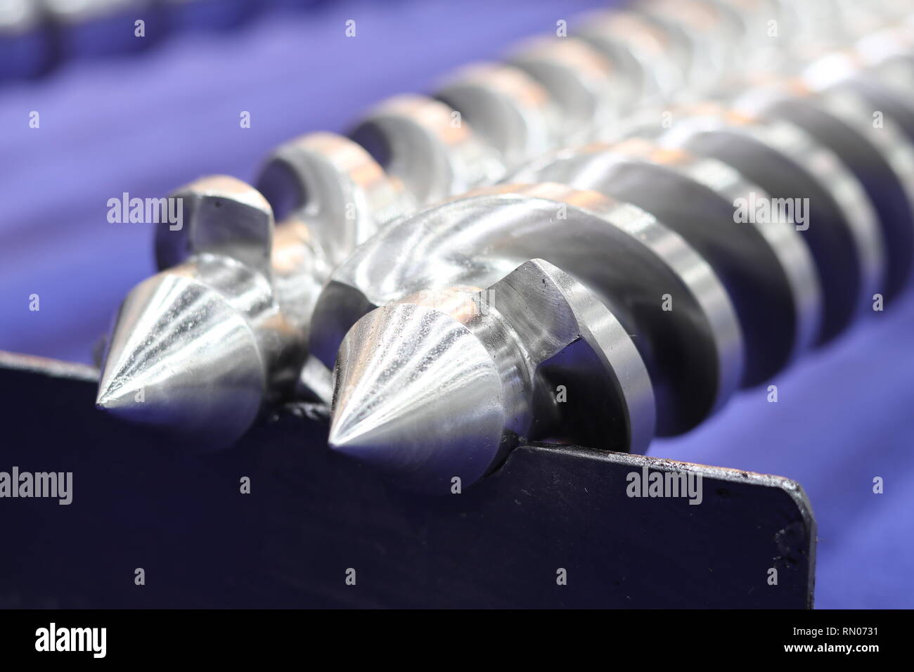 Screw press parts for plastic injection machine ; selective focus Stock Photo