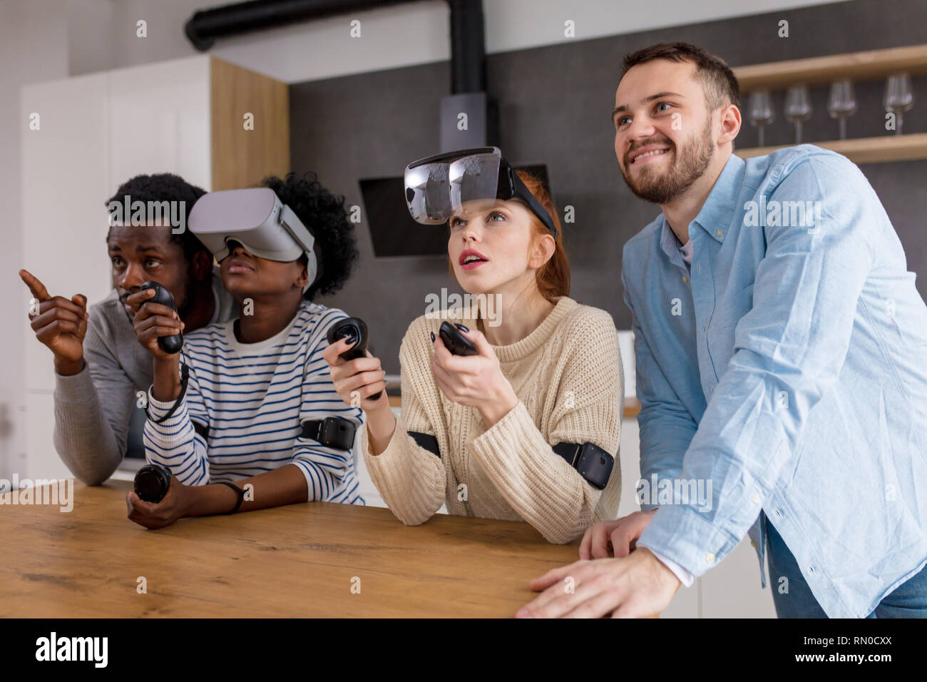 Group of young multicultural diverse friends play at home with internet ...