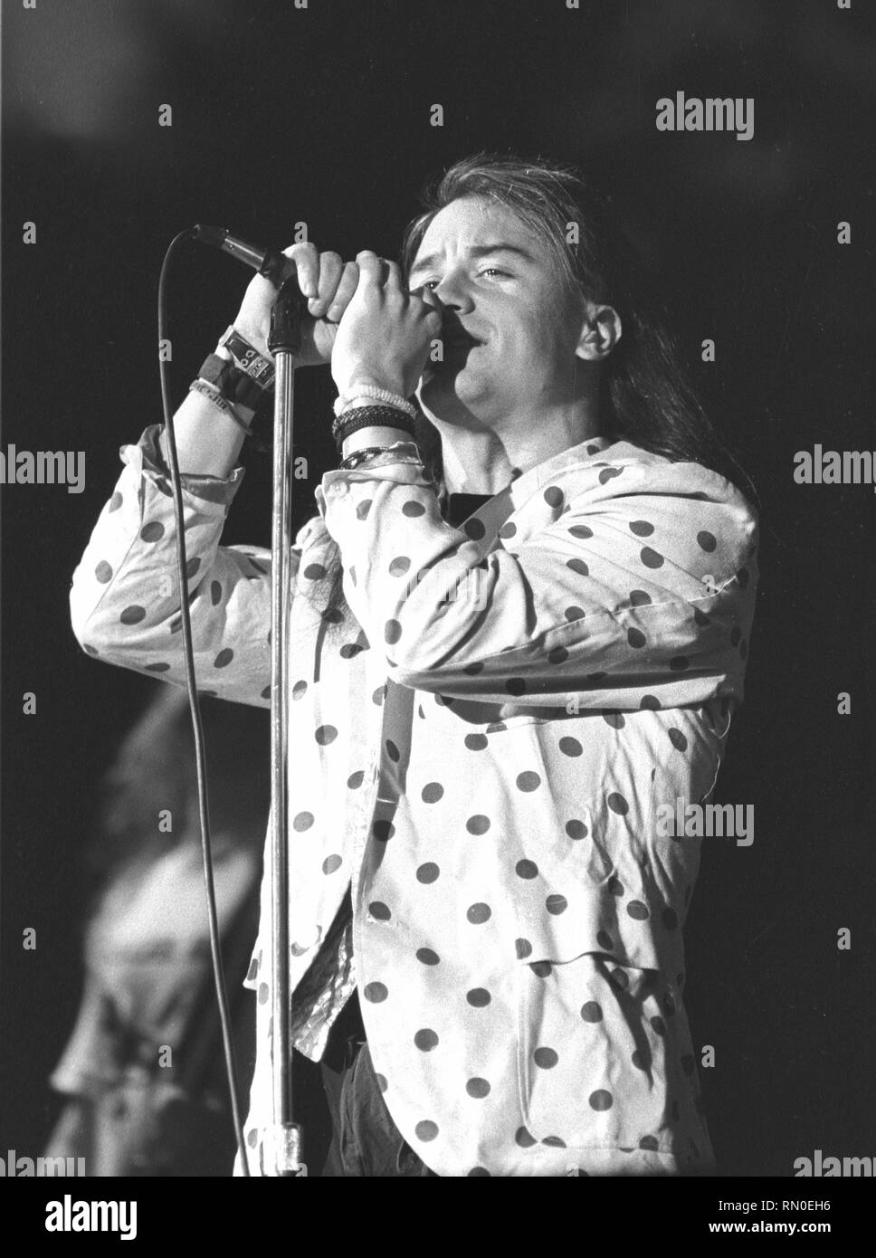 Singer Mike Patton of the alternative rock band Faith No More is shown performing on stage during a 'live' concert appearance. Stock Photo