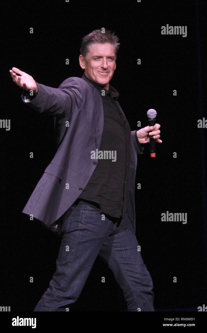 Craig Ferguson, television host, stand-up comedian, writer, actor, director, author, producer and voice artist, is shown performing on stage during a 'live' concert appearance. Stock Photo