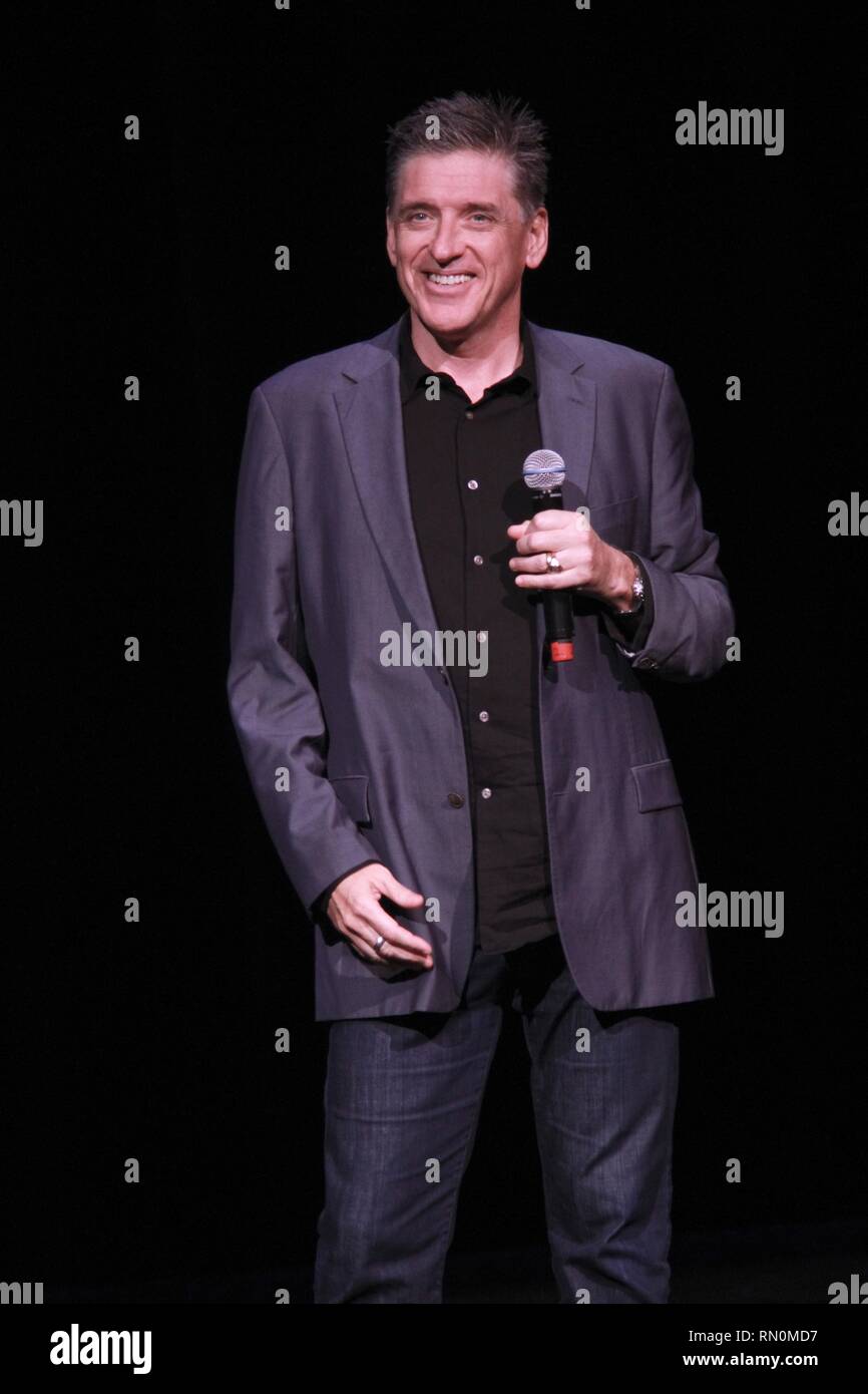 Craig Ferguson, television host, stand-up comedian, writer, actor, director, author, producer and voice artist, is shown performing on stage during a "live" concert appearance. Stock Photo