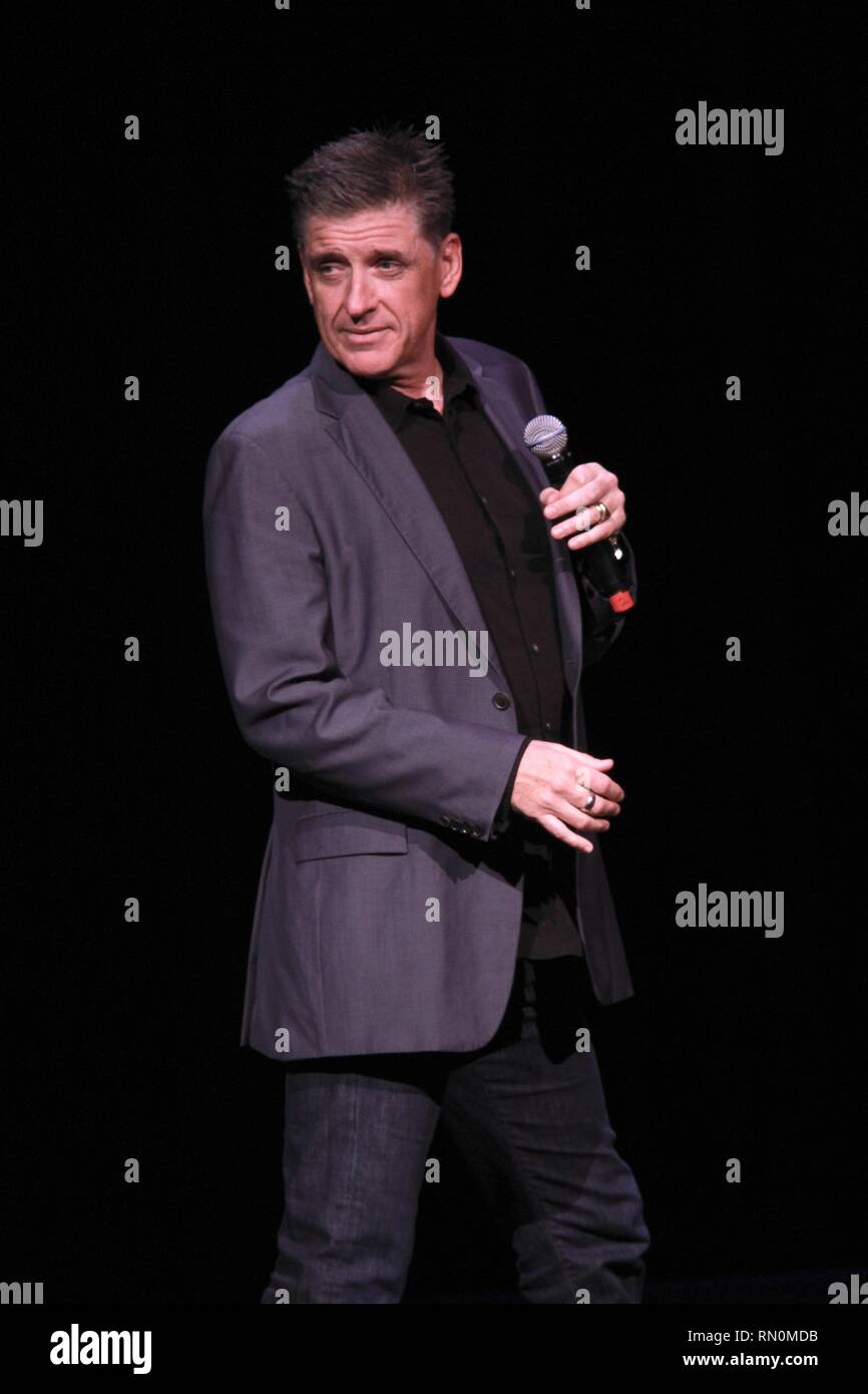 Craig Ferguson, television host, stand-up comedian, writer, actor, director, author, producer and voice artist, is shown performing on stage during a 'live' concert appearance. Stock Photo