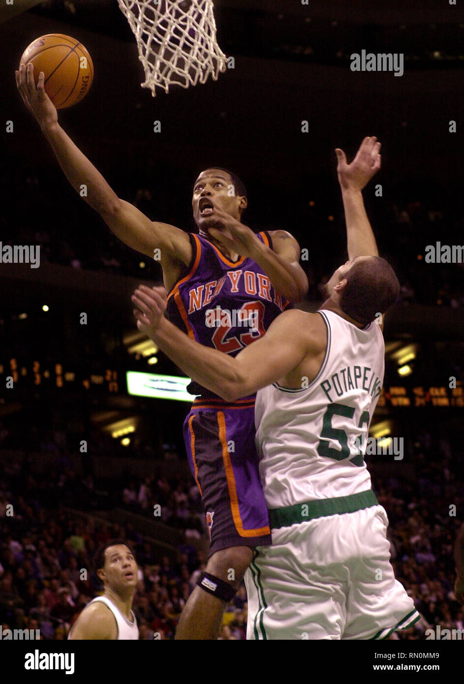 NEW YORK KNICKS MARCUS CAMBY SCORES THE WINNING GO AHEAD TWO POINTER IN OVERTIME ACTION AGAINST BOSTON  CELTIC VITALY POTAPENKO  AT THE FLEET CENTER IN BOSTON MA USA,11-10-2000  PHOTO BY BILL BELKNAP Stock Photo