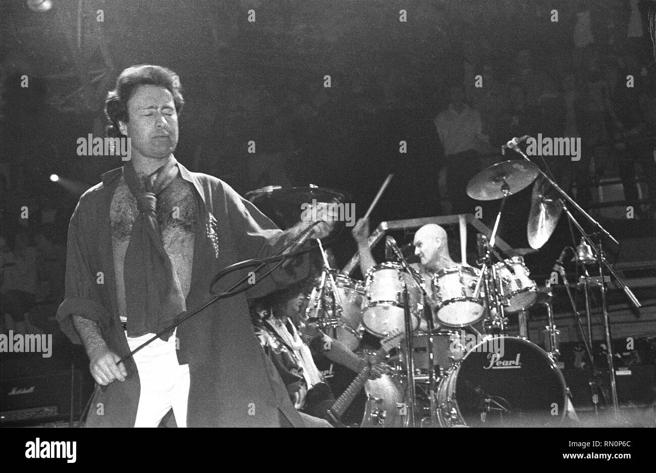 Singer Paul Rodgers is shown performing in stage during a 'live' concert appearance with The Firm. Stock Photo