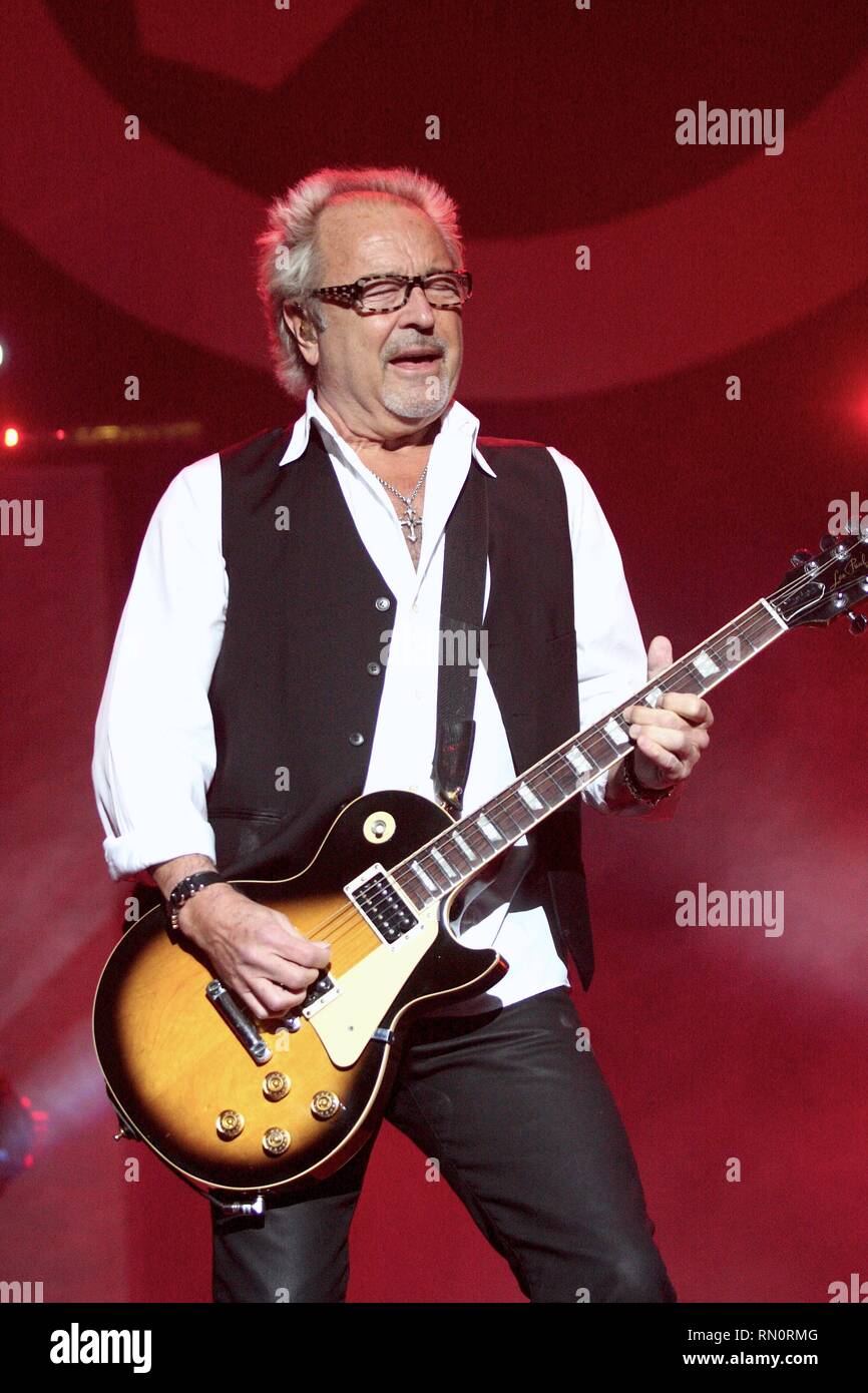 Foreigner guitarist and founding member Mick Jones  is shown performing on stage during a 'live' concert appearance. Stock Photo
