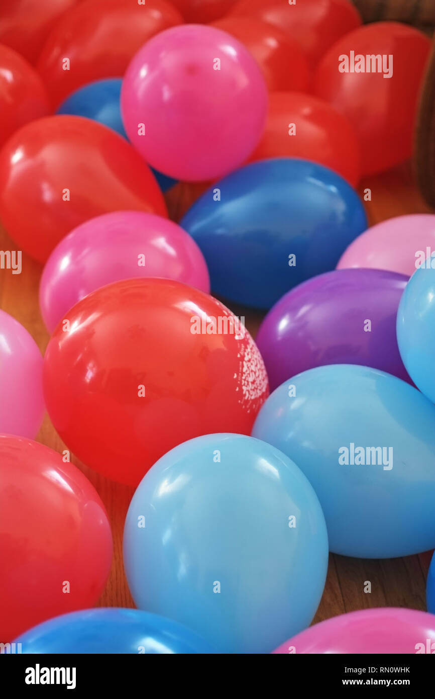 Colorful party balloon background with dozens of balloons glisten Stock